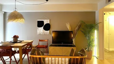 a living room with a table and a television at Chic Retreat by Santa Monica in Los Angeles