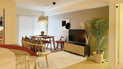 a living room with a dining room table and a television at Chic Retreat by Santa Monica in Los Angeles