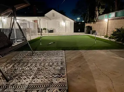 a backyard with a miniature golf course at night at New cheerful villa, Pool, Spa, Mini Golf, Game room, Fire pit next to Disneyland in Anaheim