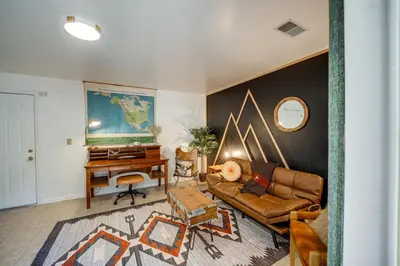 a living room with a couch and a piano at Pinon Pines Vacation Rental Hike, Bike and ATV! in Pine Mountain Club