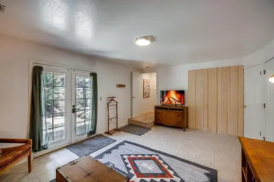 a living room with a fireplace and a tv at Pinon Pines Vacation Rental Hike, Bike and ATV! in Pine Mountain Club