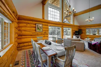 a dining room and living room with a table and chairs at Pinon Pines Vacation Rental Hike, Bike and ATV! in Pine Mountain Club