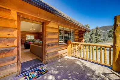 a log cabin with a balcony and a living room at Pinon Pines Vacation Rental Hike, Bike and ATV! in Pine Mountain Club