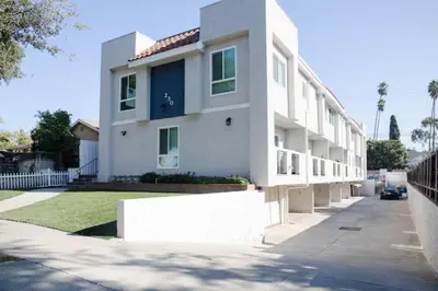 a white apartment building with a white wall at New Renovated Spacious 3 bedroom near DT Alhambra in Alhambra
