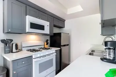 a kitchen with a white stove and a microwave at New Renovated Spacious 3 bedroom near DT Alhambra in Alhambra
