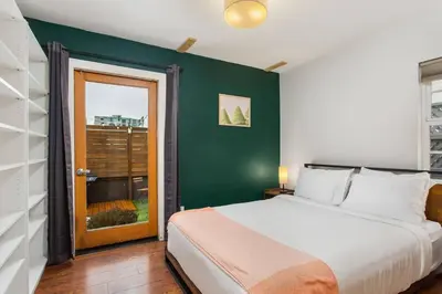 a bedroom with a bed and a green wall at Downtown Culver City House w/ Backyard, AC & Garage in Los Angeles