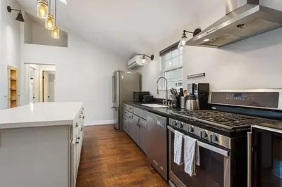 a kitchen with stainless steel appliances and a counter at Downtown Culver City House w/ Backyard, AC & Garage in Los Angeles