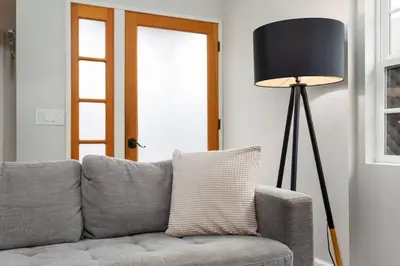 a living room with a gray couch and a lamp at Downtown Culver City House w/ Backyard, AC & Garage in Los Angeles