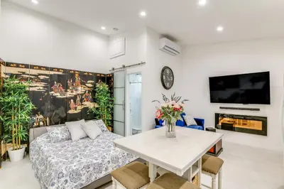 a living room with a couch and a table at 9 Mi to Dodger Stadium! East LA Studio with Patio in East Los Angeles