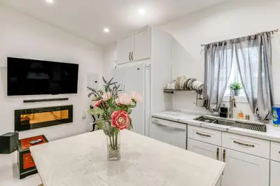 a kitchen with a vase of flowers on a table at 9 Mi to Dodger Stadium! East LA Studio with Patio in East Los Angeles