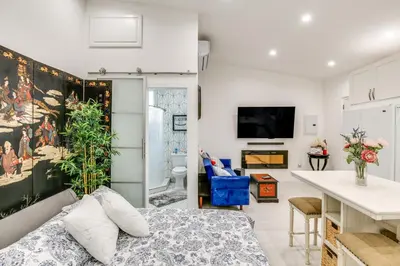a living room with a large painting on the wall at 9 Mi to Dodger Stadium! East LA Studio with Patio in East Los Angeles