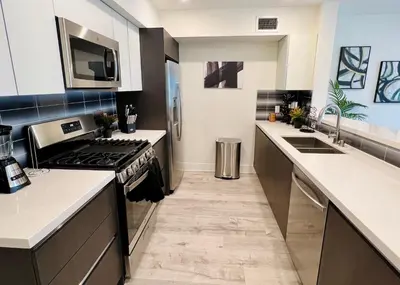 a large kitchen with a stove and a sink at Century City Chic 4 sleep free parking 402 in Los Angeles