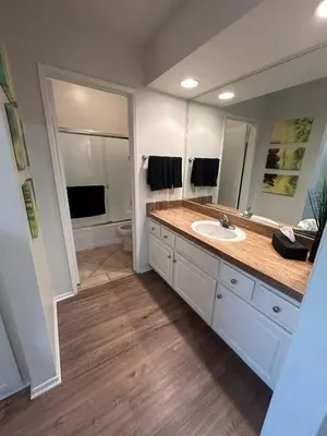 a bathroom with a sink and a large mirror at Beverly Hills Midle City 1 br Apt with Parking 202 in Los Angeles