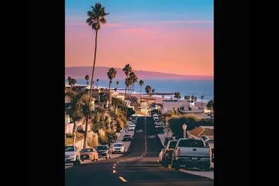 a street with cars parked on the road with palm trees at Beverly Hills Midle City 1 br Apt with Parking 202 in Los Angeles