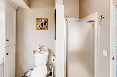 a bathroom with a toilet and a shower at Fernrock Cabin in Twin Peaks