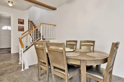 a dining room with a wooden table and chairs at Restmoore Big Bear~ Lakeside Condo Retreat~ in Big Bear Lake