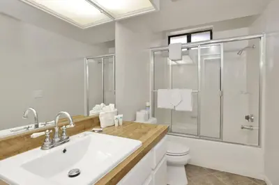 a bathroom with a sink and a shower and a toilet at Restmoore Big Bear~ Lakeside Condo Retreat~ in Big Bear Lake