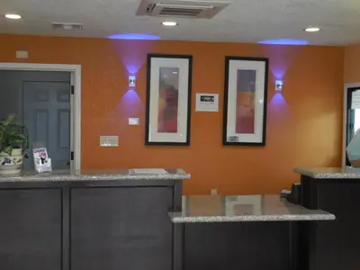 a room with three mirrors on a wall with a counter at Best Economy Inn & Suites in Bakersfield
