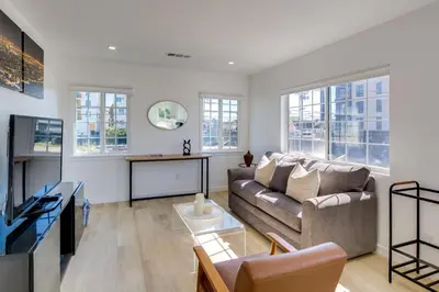 a living room with a couch and a table at 5 Mi to Venice Beach Chic Los Angeles Abode in Los Angeles