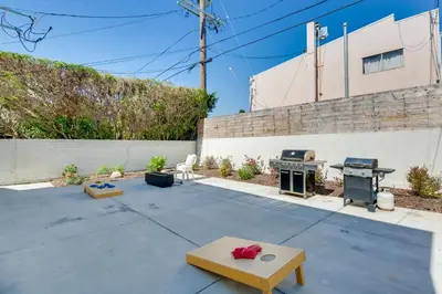a patio with a grill and a fire pit at 5 Mi to Venice Beach Chic Los Angeles Abode in Los Angeles