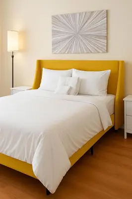 a large bed with a yellow headboard and white pillows at Adorable and Bright 2BD 2BR 740 in Los Angeles