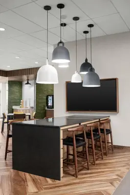 a dining room with a table and chairs and pendant lights at Fairfield by Marriott Inn & Suites Victorville in Victorville