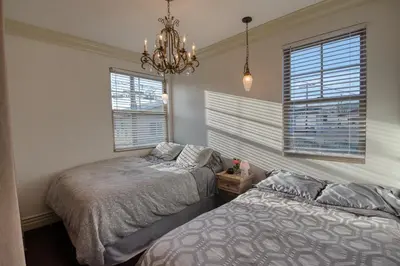 a bedroom with two beds and a chandelier at Luxury 2 bed 1 bath in Torrance