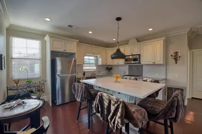 a kitchen with a large island with bar stools at Luxury 2 bed 1 bath in Torrance