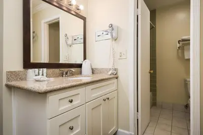 a bathroom with a sink and a mirror at Bokai Garden Hotel in Rosemead
