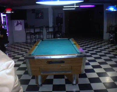 a pool table in a room with a checkered floor at Wasco Inn in Wasco
