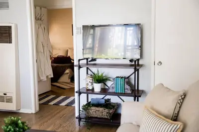 a living room with a couch and a table with plants at Seaside Bliss -Downtown! Beach! ConvCenter! Bikes! in Long Beach