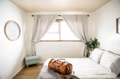 a bedroom with a bed with a bag on it at Seaside Bliss -Downtown! Beach! ConvCenter! Bikes! in Long Beach
