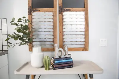 a table with books and a window in a kitchen at Seaside Bliss -Downtown! Beach! ConvCenter! Bikes! in Long Beach