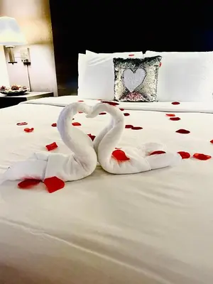 two swans making a heart shape on a bed at GreenTree Inn & Suites Los Angeles - Alhambra - Pasadena in Alhambra
