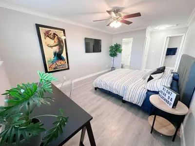 a bedroom with a bed and a table in it at Spacious South Bay Condo in Torrance