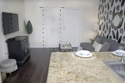 a living room with a couch and a table at LBC Cozy Suite -Downtown! Beach! in Long Beach