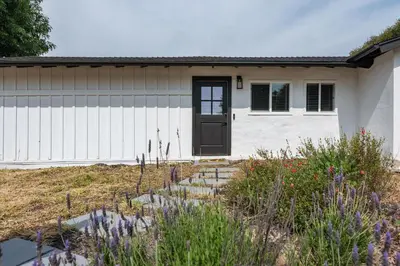a house with a black door in a yard at Private Studio Oasis with Nature at Your Doorstep in Thousand Oaks