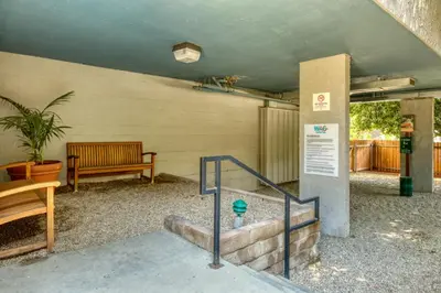 a building with a bench and stairs with a sign at Pasadena 1BR w gym pool nr Colorado Ave LAX-861 in Pasadena