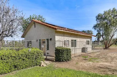 a small white house with a fence around it at Peaceful Riverside Home with Patio, 7 Mi to Downtown in Riverside