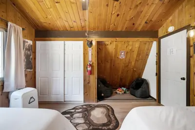 a bedroom with a bed and a wooden ceiling at Cozy Cabin near Resorts and The Village +Mtn views in Big Bear City