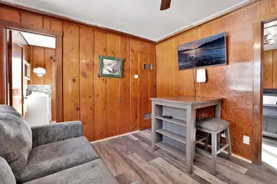 a living room with a table and a couch at Sunset Cottage Lakeside Couple's Cabin by Big Bear Vacations in Big Bear Lake