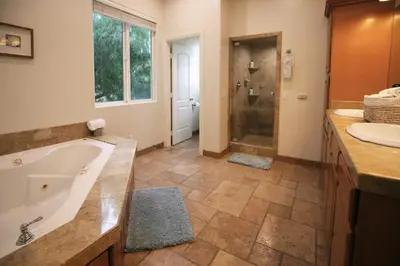 a bathroom with a tub and a shower and a sink at 5 BR/5 BA Getaway with a View in Thousand Oaks