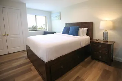 a bedroom with a large bed and a table with a lamp at 5 BR/5 BA Getaway with a View in Thousand Oaks