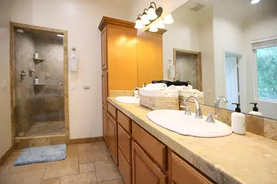 a bathroom with two sinks and a shower at 5 BR/5 BA Getaway with a View in Thousand Oaks