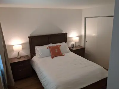 a bedroom with a large bed with two lamps at “The Grey Haven” – Secluded home in the woods in Lake Arrowhead