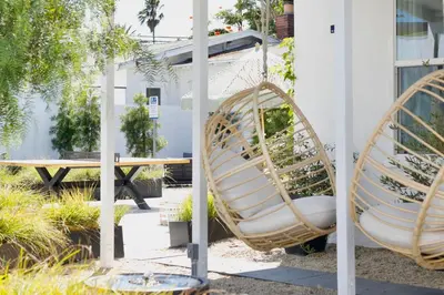 a hammock swing in a garden with a picnic table at Aliza Hotel in Los Angeles