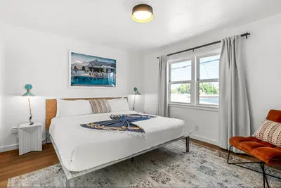 a white bedroom with a bed and a window at Aliza Hotel in Los Angeles