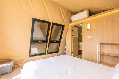 a bedroom with a bed and two windows at Glamping in the Urban in Glendora