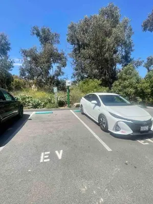 a white car parked in a parking lot at SummerLillie #1 in Summerland