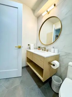a bathroom with a sink and a mirror at SummerLillie #1 in Summerland